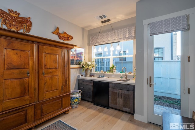 720 Marewood Trl, Reno, NV 89511 - bar area with light wood-style flooring, a sink, and healthy amount of natural light