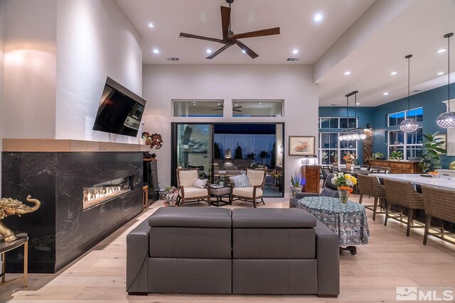 720 Marewood Trl, Reno, NV 89511 - living area featuring wood finished floors, ceiling fan, a fireplace, recessed lighting, and a high ceiling