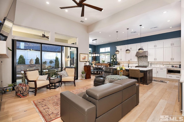 720 Marewood Trl, Reno, NV 89511 - living room featuring ceiling fan, light wood-style floors, recessed lighting, and a towering ceiling