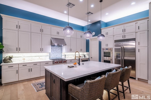 720 Marewood Trl, Reno, NV 89511 - kitchen featuring appliances with stainless steel finishes, a sink, extractor fan, light wood-style flooring, and recessed lighting