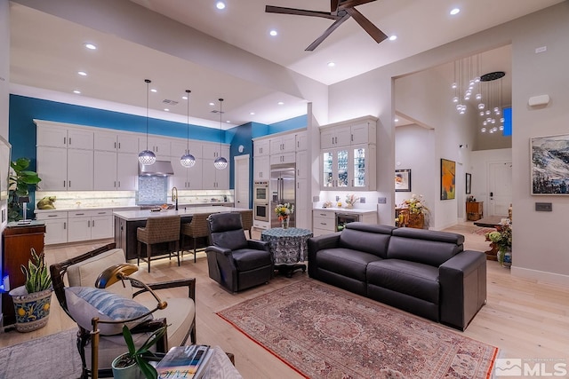 720 Marewood Trl, Reno, NV 89511 - living area with a high ceiling, light wood-style floors, a ceiling fan, wine cooler, and recessed lighting