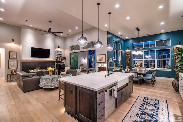 720 Marewood Trl, Reno, NV 89511 - kitchen with a sink, dishwasher, light wood finished floors, ceiling fan, and a towering ceiling