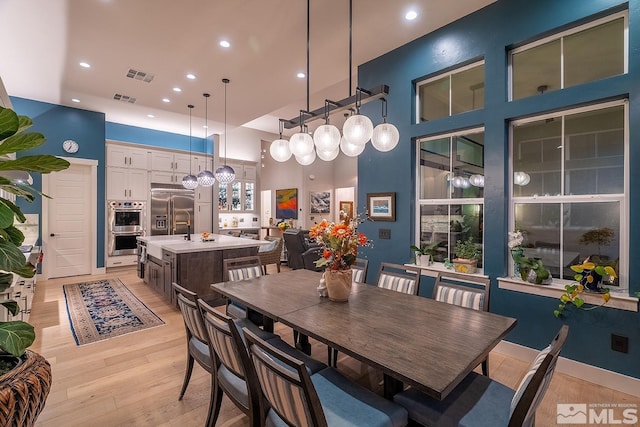 720 Marewood Trl, Reno, NV 89511 - dining area with light wood-type flooring, recessed lighting, and a high ceiling