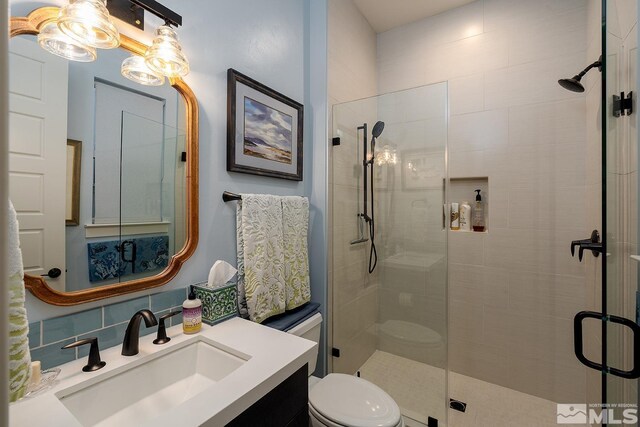 720 Marewood Trl, Reno, NV 89511 - full bathroom featuring a stall shower, toilet, vanity, and decorative backsplash