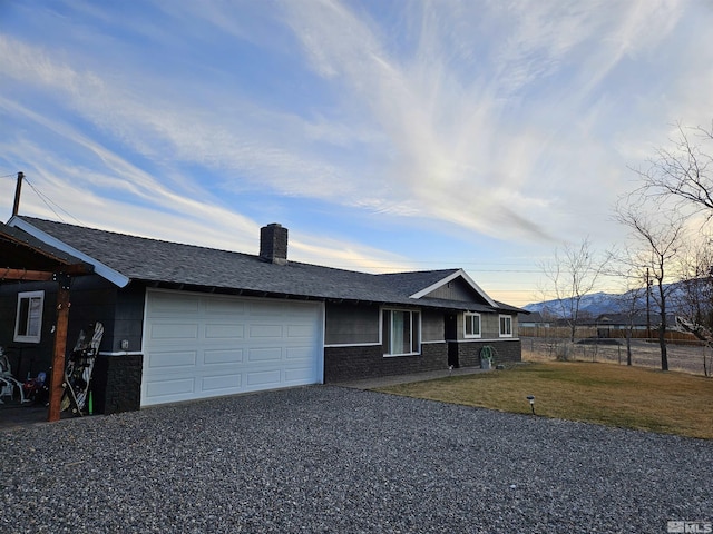 1391 Langley Dr, Gardnerville, NV 89460 - single story home with a garage, a chimney, driveway, brick siding, and a shingled roof