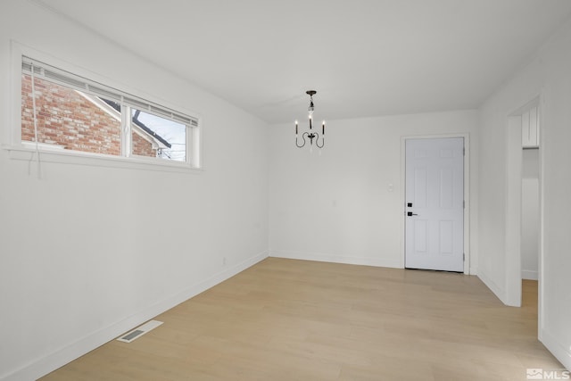 939 Bates Ave, Reno, NV 89502 - empty room with a chandelier, light wood-style flooring, and baseboards