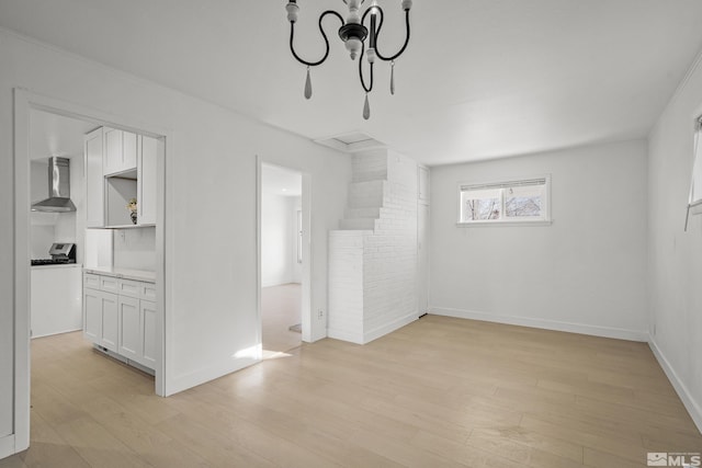 939 Bates Ave, Reno, NV 89502 - unfurnished living room featuring light wood finished floors, baseboards, and a chandelier
