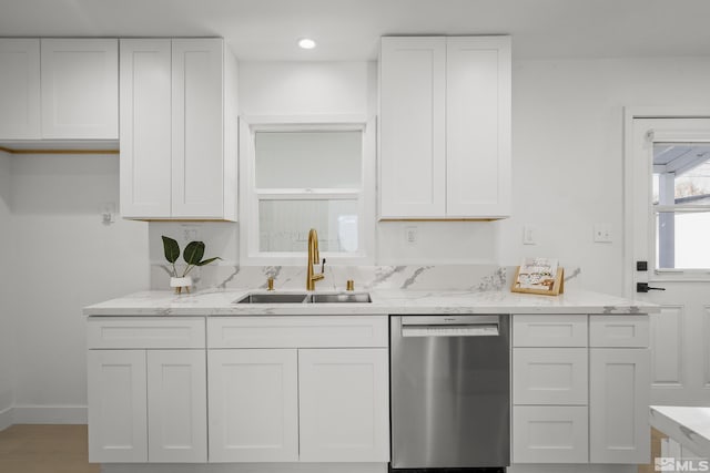 939 Bates Ave, Reno, NV 89502 - kitchen with dishwasher, a sink, white cabinets, light stone counters, and baseboards