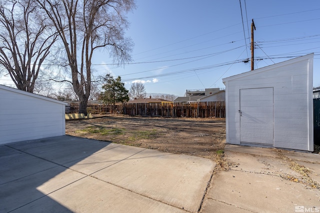 939 Bates Ave, Reno, NV 89502 - view of yard featuring fence, a patio, a shed, and an outbuilding
