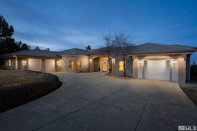 1150 Eagle Vista Ct, Reno, NV 89511 - view of front of home with stone siding, an attached garage, and concrete driveway