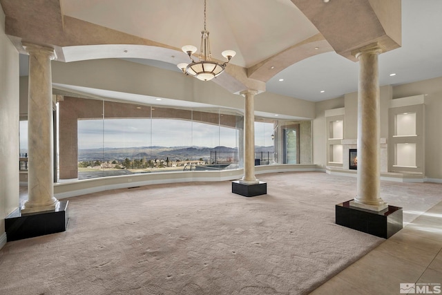 1150 Eagle Vista Ct, Reno, NV 89511 - unfurnished living room with decorative columns, recessed lighting, a high ceiling, carpet floors, and tile patterned floors