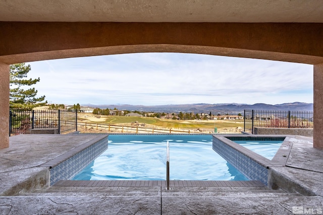 1150 Eagle Vista Ct, Reno, NV 89511 - view of pool featuring a mountain view, fence, a patio, and a pool with connected hot tub