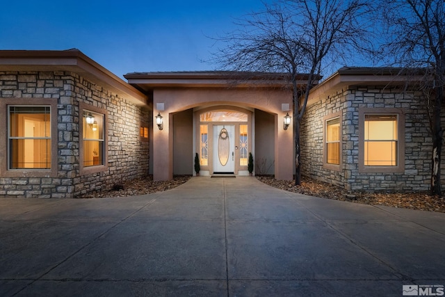 1150 Eagle Vista Ct, Reno, NV 89511 - doorway to property featuring stone siding and stucco siding