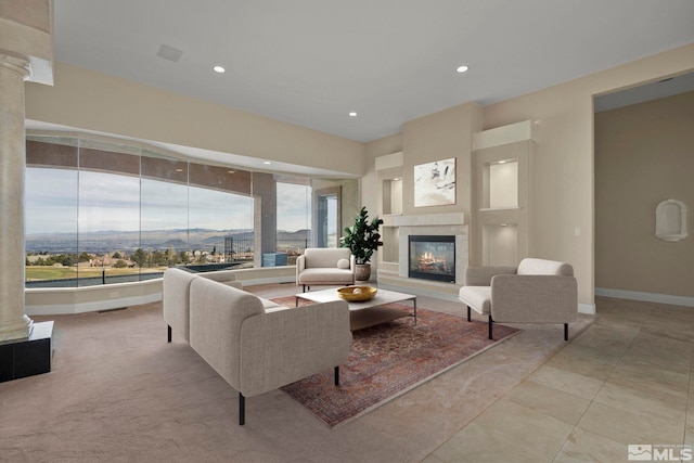 1150 Eagle Vista Ct, Reno, NV 89511 - living room featuring a tile fireplace, decorative columns, recessed lighting, and baseboards
