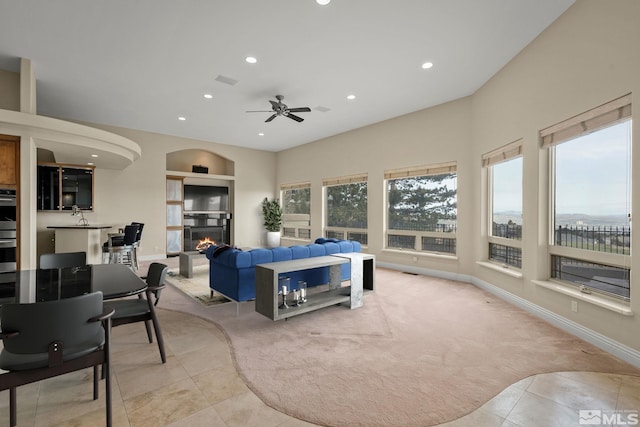 1150 Eagle Vista Ct, Reno, NV 89511 - carpeted bedroom with recessed lighting, tile patterned floors, a warm lit fireplace, baseboards, and a ceiling fan