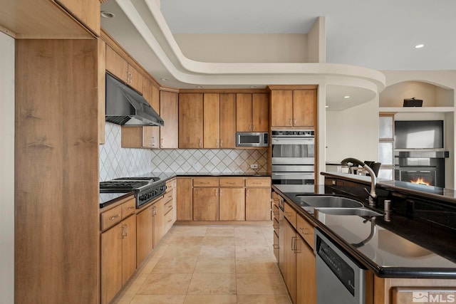 1150 Eagle Vista Ct, Reno, NV 89511 - kitchen with a sink, appliances with stainless steel finishes, under cabinet range hood, dark countertops, and backsplash