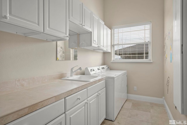 1150 Eagle Vista Ct, Reno, NV 89511 - laundry area featuring washing machine and dryer, cabinet space, baseboards, and light tile patterned floors
