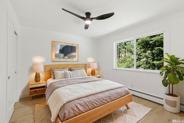 421 Edgewood Dr, Stateline, NV 89449 - bedroom featuring a baseboard radiator, light wood finished floors, a closet, and a ceiling fan