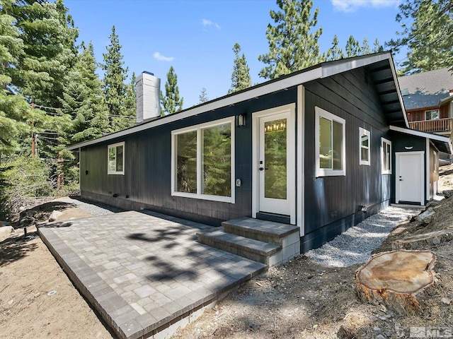 421 Edgewood Dr, Stateline, NV 89449 - rear view of house with a chimney and a patio area