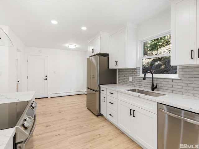421 Edgewood Dr, Stateline, NV 89449 - kitchen featuring stainless steel appliances, a sink, tasteful backsplash, white cabinetry, and light wood finished floors