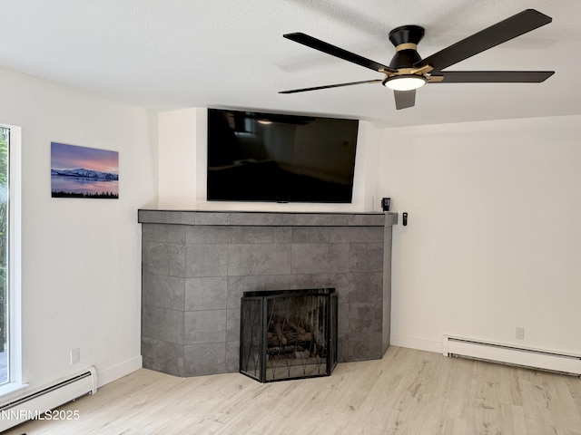 421 Edgewood Dr, Stateline, NV 89449 - unfurnished living room with baseboard heating, wood finished floors, and ceiling fan