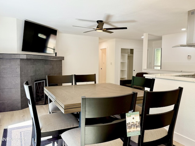 421 Edgewood Dr, Stateline, NV 89449 - dining area with light wood finished floors, ceiling fan, a tiled fireplace, and recessed lighting