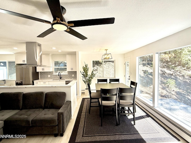 421 Edgewood Dr, Stateline, NV 89449 - dining space with baseboard heating, light wood-type flooring, plenty of natural light, ceiling fan, and recessed lighting