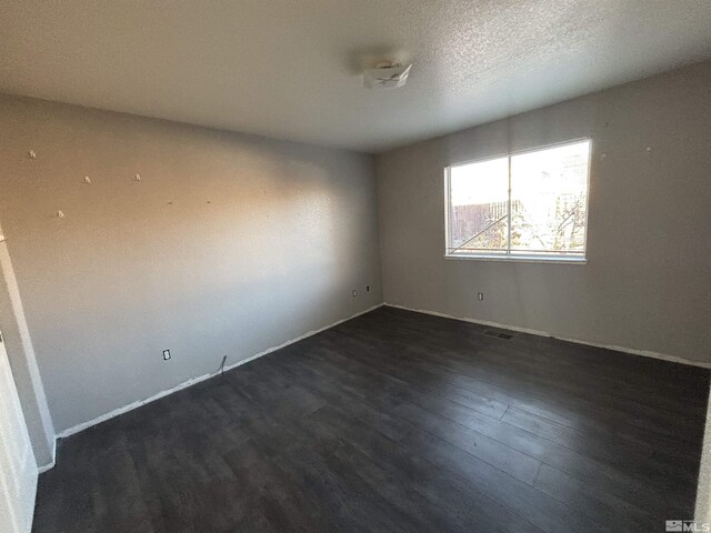 6515 Galice Ct, Sun Valley, NV 89433 - empty room with dark wood-style floors and baseboards