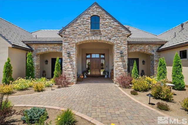 6645 De Chardin Ln, Reno, NV 89511 - doorway to property featuring stone siding, stucco siding, and french doors