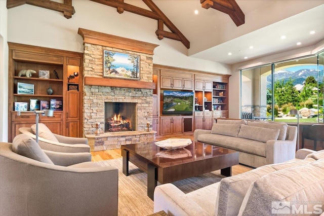 6645 De Chardin Ln, Reno, NV 89511 - living room featuring light wood-style flooring, recessed lighting, beam ceiling, a stone fireplace, and high vaulted ceiling