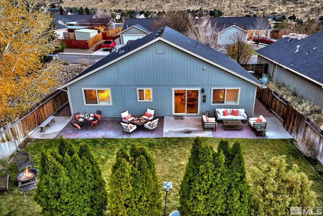 back of house featuring an outdoor living space, a patio, and a residential view