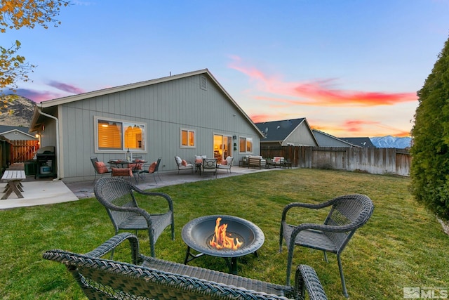 rear view of house featuring an outdoor fire pit and a patio