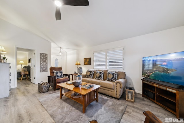 living room with wood finished floors, ceiling fan, and lofted ceiling