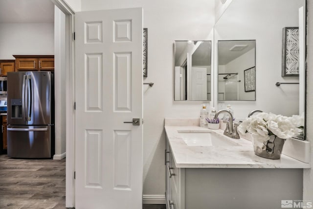 bathroom with wood finished floors and vanity