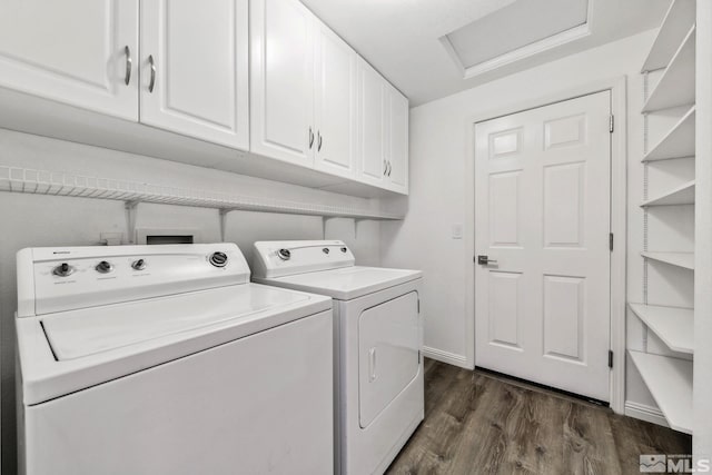 clothes washing area with washer and dryer, cabinet space, dark wood finished floors, attic access, and baseboards