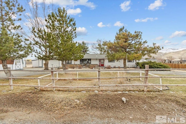 8700 Little Creek Rd, Reno, NV 89508 - ranch-style home featuring a fenced front yard, a mountain view, and a shed