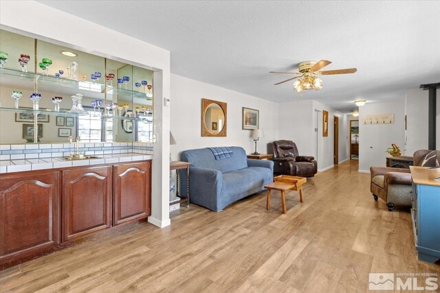 8700 Little Creek Rd, Reno, NV 89508 - living room with light wood-type flooring, ceiling fan, and baseboards