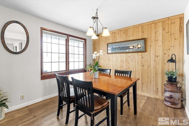 8700 Little Creek Rd, Reno, NV 89508 - dining area with wooden walls, wood finished floors, baseboards, and a chandelier