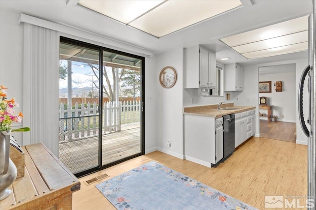 8700 Little Creek Rd, Reno, NV 89508 - kitchen featuring dishwasher, light countertops, light wood-style flooring, a sink, and refrigerator