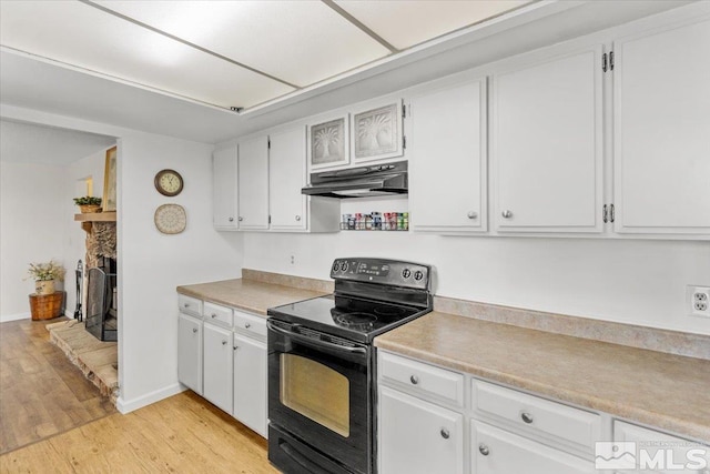 8700 Little Creek Rd, Reno, NV 89508 - kitchen featuring black electric range oven, under cabinet range hood, light wood-style floors, light countertops, and white cabinets