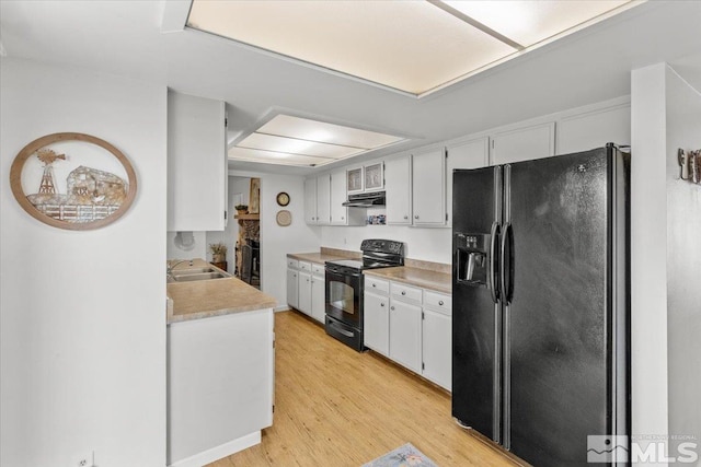 8700 Little Creek Rd, Reno, NV 89508 - kitchen featuring black appliances, under cabinet range hood, light wood-type flooring, light countertops, and a sink
