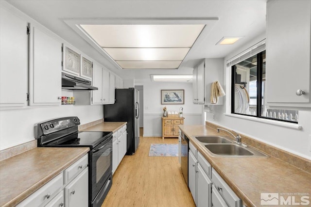 8700 Little Creek Rd, Reno, NV 89508 - kitchen with black / electric stove, under cabinet range hood, a sink, light wood-style floors, and freestanding refrigerator