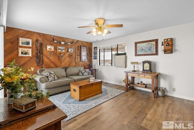 8700 Little Creek Rd, Reno, NV 89508 - living area with a ceiling fan, wood walls, baseboards, and wood finished floors