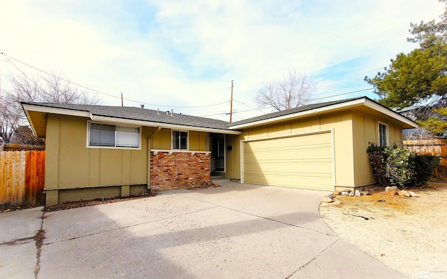 1285 Rayburn Dr, Reno, NV 89503 - ranch-style home with a garage, fence, driveway, board and batten siding, and a shingled roof