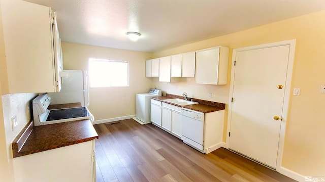 1285 Rayburn Dr, Reno, NV 89503 - kitchen featuring white appliances, a sink, washer / dryer, wood finished floors, and dark countertops