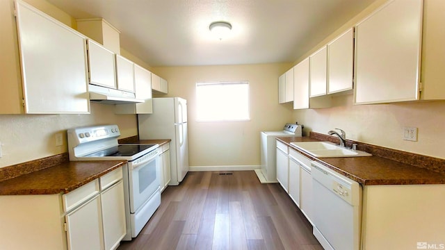 1285 Rayburn Dr, Reno, NV 89503 - kitchen featuring white appliances, a sink, under cabinet range hood, washer and clothes dryer, and dark countertops