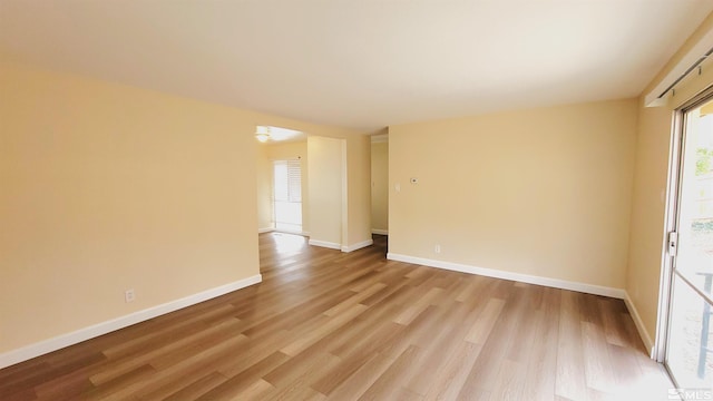 1285 Rayburn Dr, Reno, NV 89503 - empty room with light wood-style flooring, plenty of natural light, and baseboards