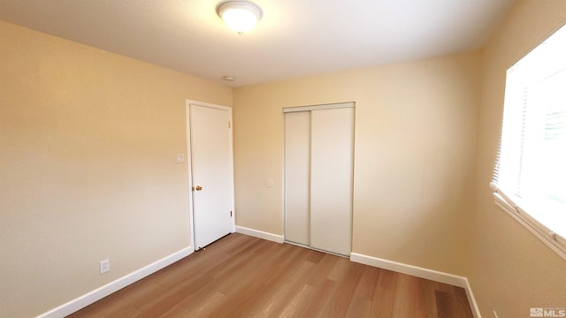 1285 Rayburn Dr, Reno, NV 89503 - unfurnished bedroom featuring light wood-type flooring, baseboards, and a closet