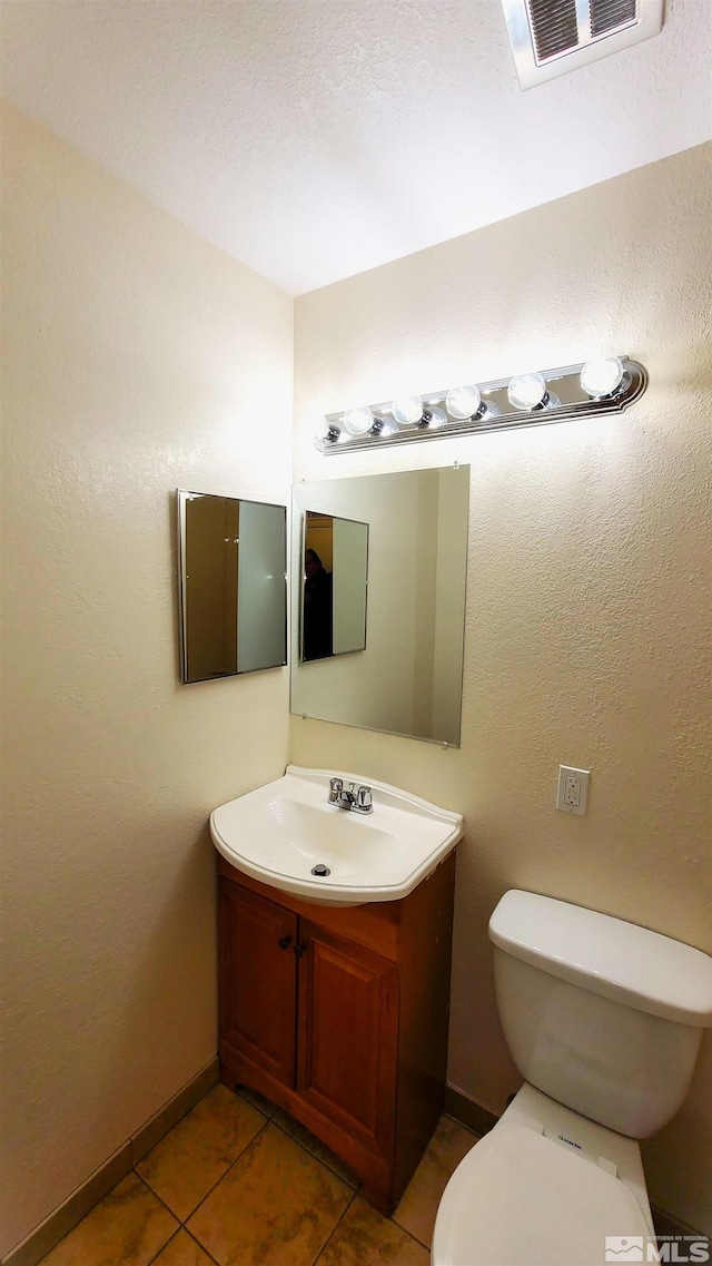 1285 Rayburn Dr, Reno, NV 89503 - bathroom featuring tile patterned floors, vanity, toilet, and baseboards