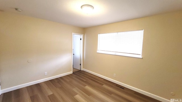 1285 Rayburn Dr, Reno, NV 89503 - spare room featuring baseboards, wood finished floors, and a smoke detector
